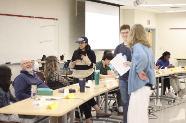  Taking a break from discussion, teachers and panelists converse among themselves and prepare thoughts for the next questions. The SGA-organized town hall brought class representatives and teachers together to discuss student concerns, student wellness and school policy. 